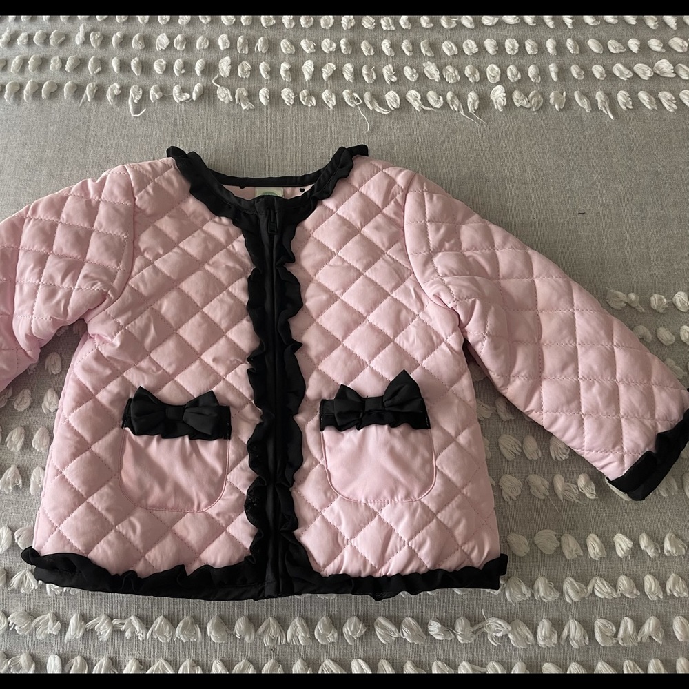 Pink channel style quilt jacket with black bows and ruffle trim